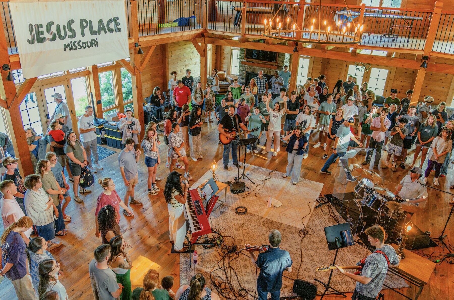 The Jesus Place Missouri community worshiping together in a wooden gathering space