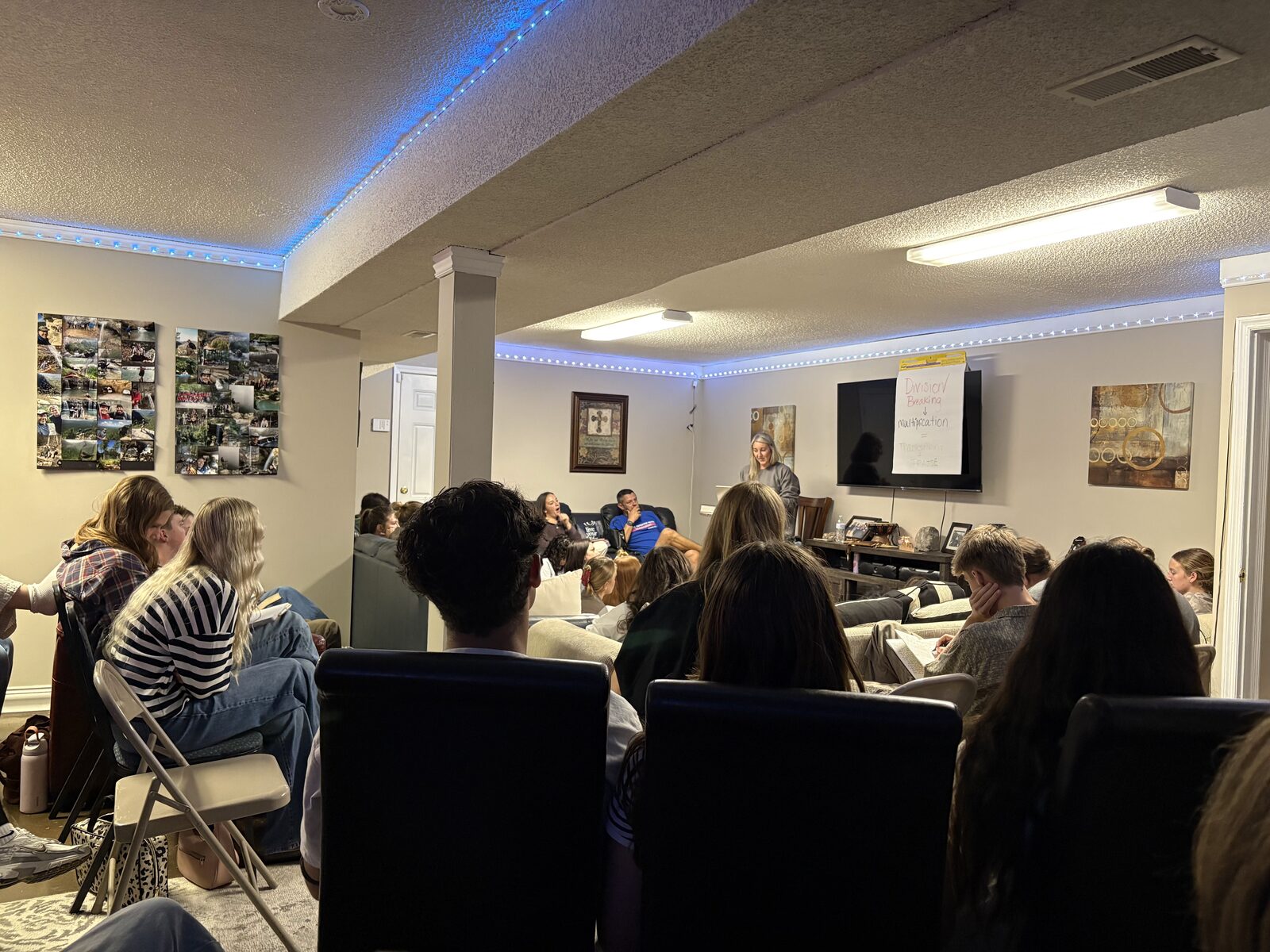 A room full of young people gathered on couches and chairs listening during a Communion Night